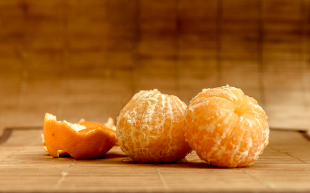 Peeled mandarins on the tableの写真素材