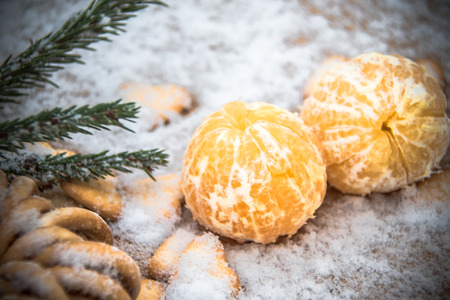Mandarins, snow, spruce branches - Christmas background and concept of the new compositionの写真素材