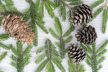 Christmas wooden background made of fir branches and conesの写真素材
