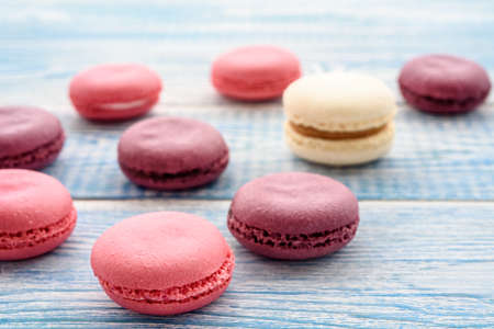 Sweet macarons on a blue  background. Trendy cakes.の写真素材