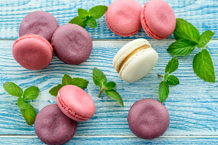 Sweet macarons on a blue  background. Trendy cakes.の写真素材