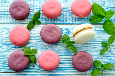 Sweet macarons on a blue  background. Trendy cakes.の写真素材