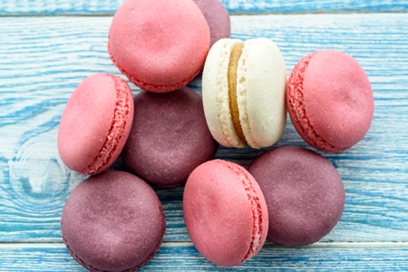 Sweet macarons on a blue  background. Trendy cakes.の写真素材