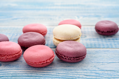 Sweet macarons on a blue  background. Trendy cakes.の写真素材