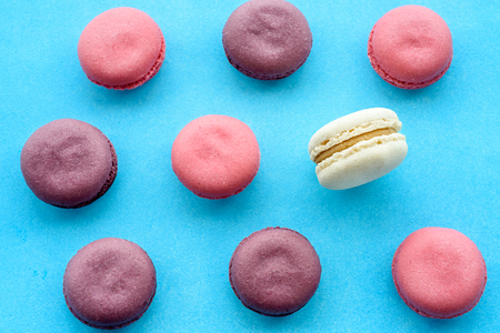 Sweet macarons on a blue  background. Trendy cakes.の写真素材