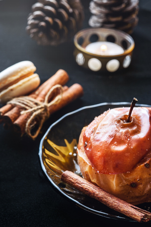 Baked Apple with cinnamon on a dark table. Still life of dessertの写真素材