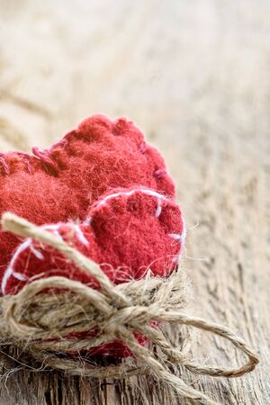 Two decorative hearts on wooden background. Symbol of love.の写真素材
