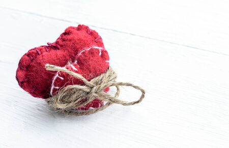 Two decorative hearts on wooden background. Symbol of love.の写真素材