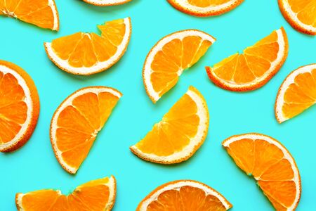 Fruit pattern of fresh orange slices on green background.の写真素材