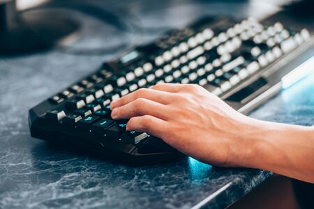 Hand man on the keyboard - tinted. The concept of computer technology and communication.