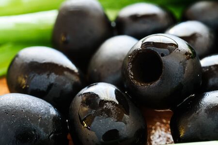 Marinated black olives on wooden backgroundの写真素材
