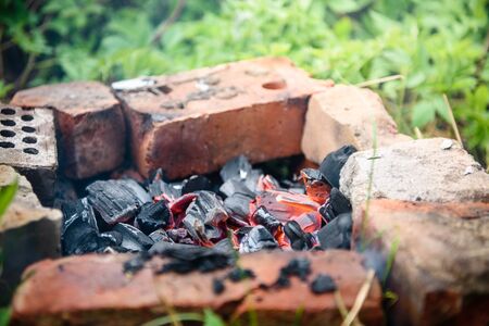 fire was made of bricks laid on the ground. Picnic barbecue camping in natureの写真素材