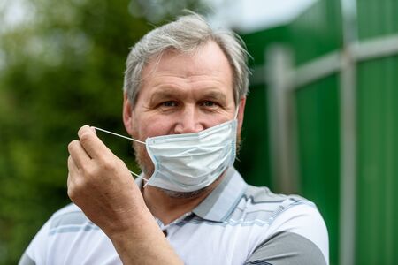 Man, medical mask and quarantine-the concept of a viral pandemicの写真素材