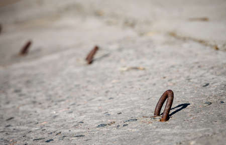 Concrete slab with metal hinges close - up-facing of a sea channel or riverのeditorial素材
