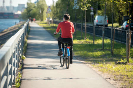 Russia, Saint Petersburg, may 30, 2020:A cyclist rides along the waterfront of the seaportのeditorial素材