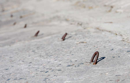 Concrete slab with metal hinges close - up-facing of a sea channel or riverのeditorial素材