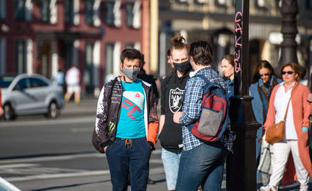 Russia, Saint Petersburg, may 30, 2020: young people in the city center protecting themselves from...
