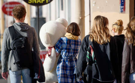Russia, Saint Petersburg, may 30, 2020: a Happy girl on the streets of the city carries a huge Teddy...