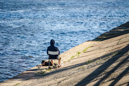 Russia, Saint Petersburg, may 30, 2020: Fisherman on the embankment of the seaportのeditorial素材