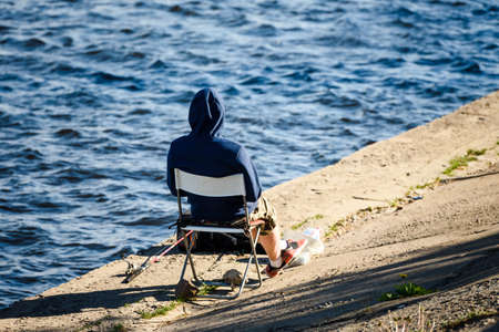 Russia, Saint Petersburg, may 30, 2020: Fisherman on the embankment of the seaportのeditorial素材