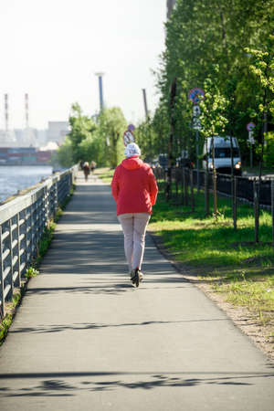 A girl alone in a commercial seaport on a walk. Russia, Saint Petersburg, may 30, 2020のeditorial素材