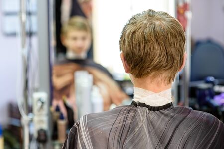 guy in a Barber shop sitting in front of a mirrorの写真素材