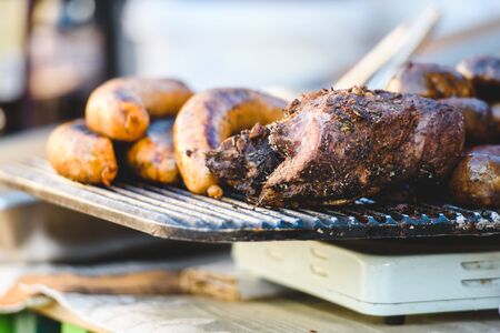Meat delicacies and smoked meats on the market counter. Bushmeat. Sausages and pork