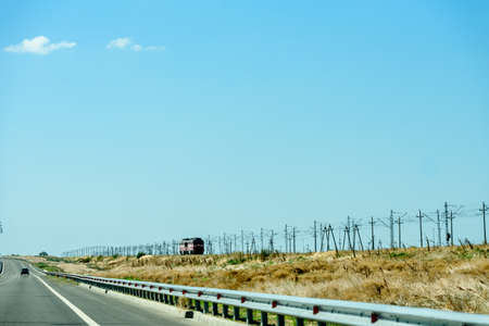 Russia, Crimea, September 11, 2019: Cars on the highway to Crimea. Railway and locomotive.のeditorial素材