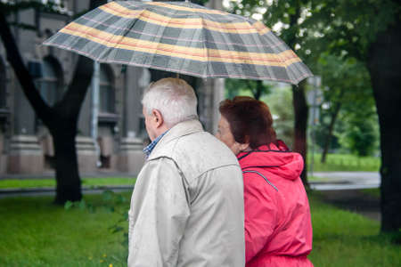 Russia Petersburg August 4, 2020: an Elderly man and a woman couple in the city-view from the backのeditorial素材