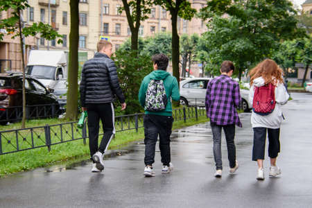 Russia Petersburg August 4, 2020: a group of teenagers strolling through the city in the summer-a view from the backのeditorial素材