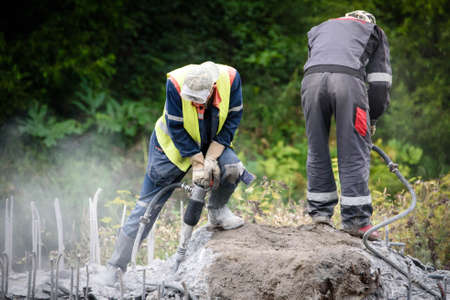 Russia Petersburg August 4, 2020: road Workers perform road and bridge repairs in the city.のeditorial素材