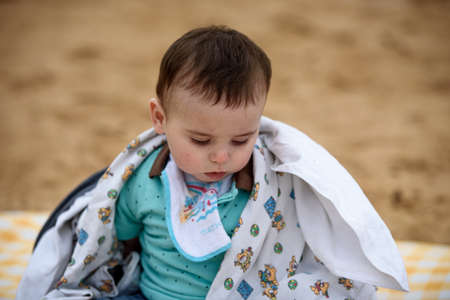 Portrait of a cute baby boy on the beach on a summer day