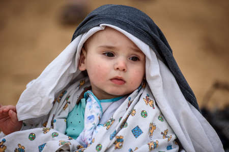Portrait of a cute baby boy on the beach on a summer day
