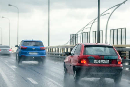 Russia, St. Petersburg, August 26, 2020: traffic on the bypass road during the rain. Bad weather and...