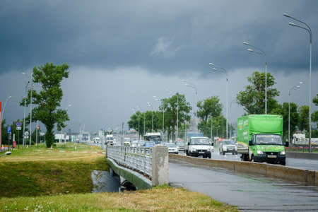 Russia, St. Petersburg, August 26, 2020: Highway with cars and departure from St. Petersburg in rainy weatherのeditorial素材