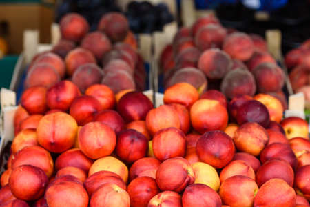Peaches on the market counter-harvest seasonの写真素材