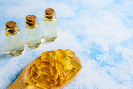 Fish oil capsules on a blue background - omega 3 vitamins and health conceptの写真素材