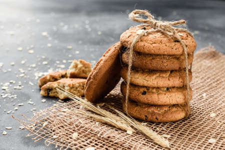 Homemade oatmeal cookies with raisins on a dark backgroundの写真素材