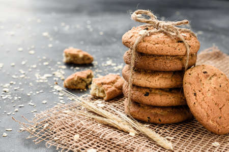 Homemade oatmeal cookies with raisins on a dark backgroundの写真素材