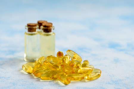 Health, vitamins and natural medicines - omega 3 capsules on a blue background.の写真素材