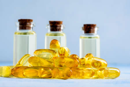 Health, vitamins and natural medicines - omega 3 capsules on a blue background.の写真素材