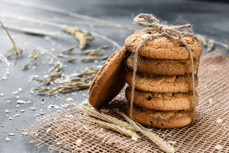 Homemade oatmeal cookies with raisins on a dark backgroundの写真素材
