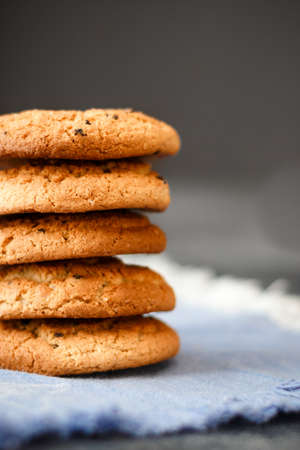 Fresh oatmeal cookies on a dark backgroundの写真素材