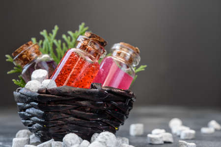 Shower gel in glass bottles and bath salt on a dark background. Spa products and body care.の写真素材