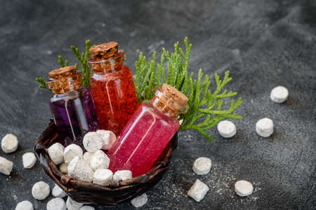 Shower gel in glass bottles and bath salt on a dark background. Spa products and body care.の写真素材