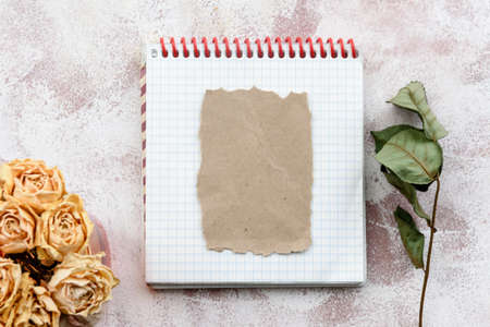 Stationery romantic delicate background-a clean notebook and yellow roses. Top view, close-up, and copy space.の写真素材