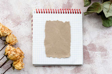 Stationery romantic delicate background-a clean notebook and yellow roses. Top view, close-up, and copy space.の写真素材