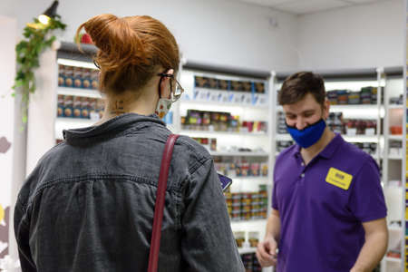Russia, May 15, 2021: seller and buyer in the store-the concept of service in the retail business.のeditorial素材