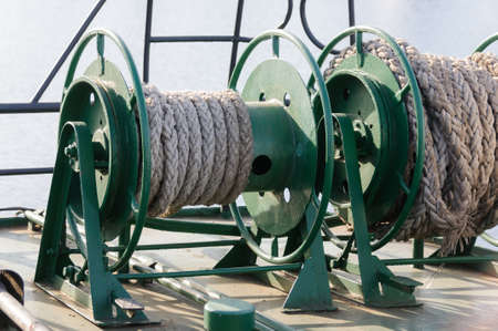 Bobbins with a rope on the deck of the ship close-upの写真素材