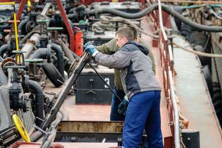 Russia, Saint Petersburg, May 2021: Two male sailors work on the deck of an oil tankerのeditorial素材